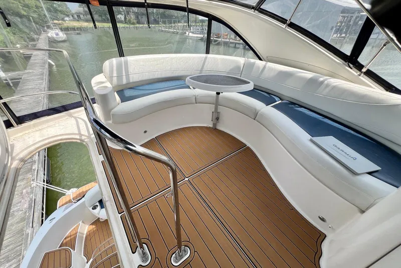Slide: The Image of 2008 Meridian 391 Sedan yacht interior with curved seating and wooden flooring. - 8