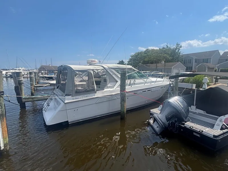 Slide: The Image of 1987 Chris-Craft 336 Amerosport docked at marina under clear blue sky. - 1