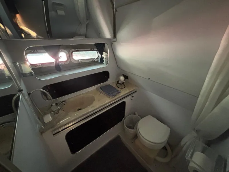 Slide: The Image of 1987 Chris-Craft 336 Amerosport bathroom with sink, mirror, and toilet. - 11