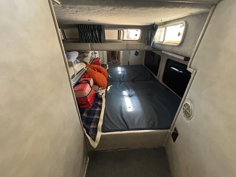 Slide: The Image of 1987 Chris-Craft 336 Amerosport cabin interior with bed and storage space. - 12