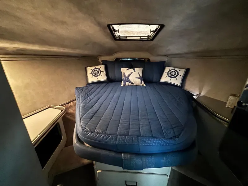 Slide: The Image of Cozy cabin interior of 1987 Chris-Craft 336 Amerosport with blue bedding and nautical decor. - 14