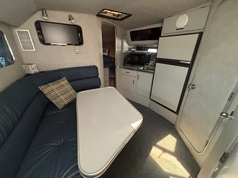 Slide: The Image of 1987 Chris-Craft 336 Amerosport cabin interior with seating, table, and kitchenette. - 17