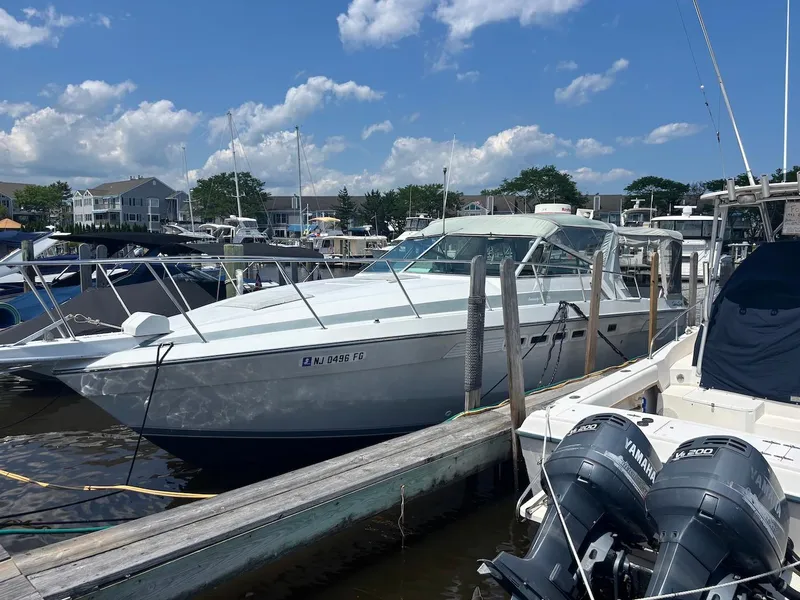 Slide: The Image of 1987 Chris-Craft 336 Amerosport docked at marina under blue sky. - 2