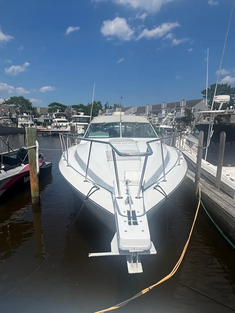 Slide: The Image of 1987 Chris-Craft 336 Amerosport boat docked in marina under clear blue sky. - 3