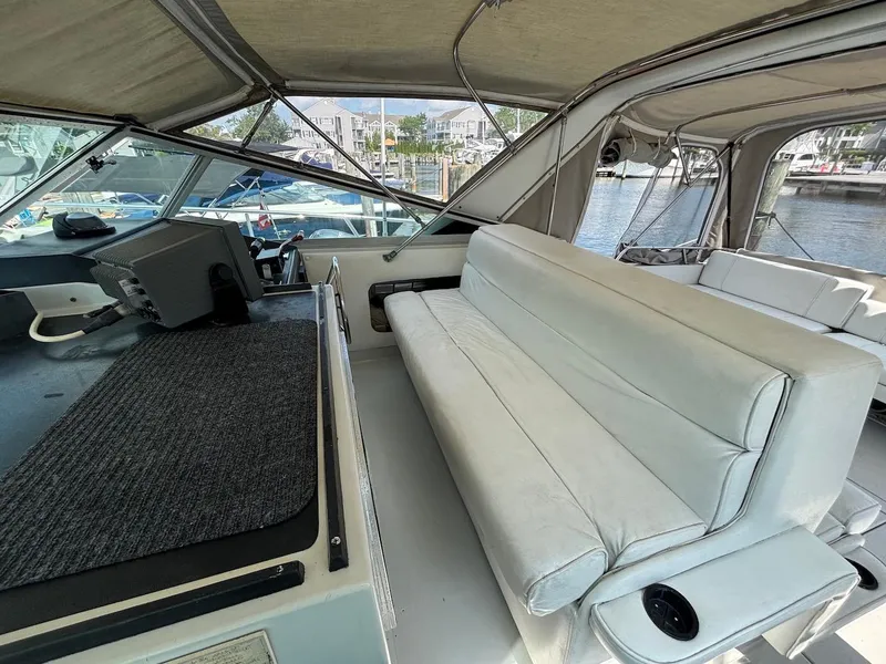 Slide: The Image of 1987 Chris-Craft 336 Amerosport boat interior with white seating and helm station. - 6