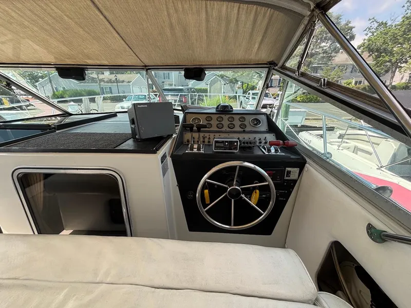 Slide: The Image of 1987 Chris-Craft 336 Amerosport boat cockpit with steering wheel and control panel. - 7