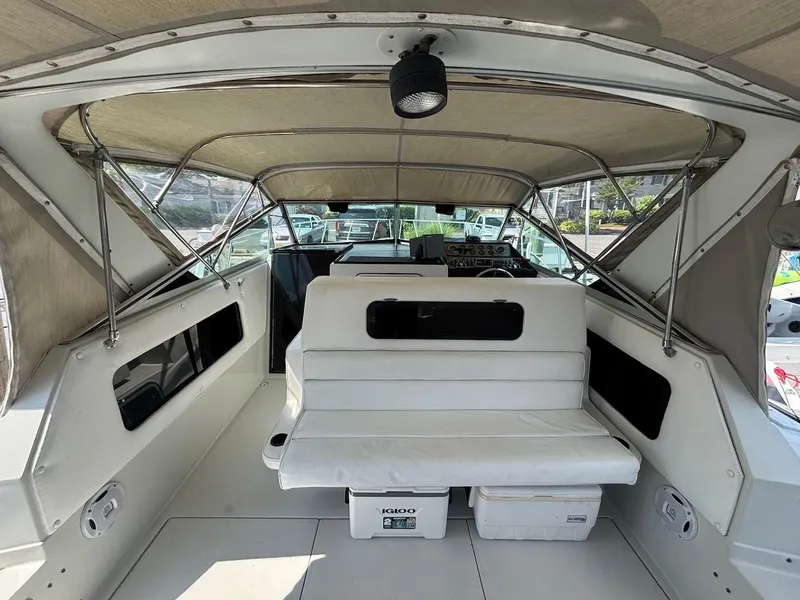 Slide: The Image of 1987 Chris-Craft 336 Amerosport boat interior with seating and helm, featuring a covered cockpit. - 8