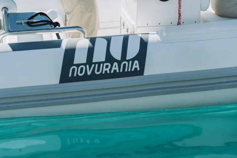 Slide: The Image of Novurania DL 550 boat, 2026 model, on turquoise water. - 8