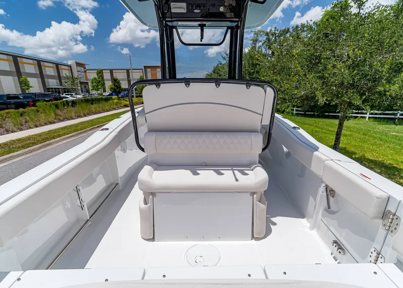 Slide: The Image of 2026 Sea Hunt Ultra 245 SE boat interior with white seating, outdoors on a sunny day. - 11