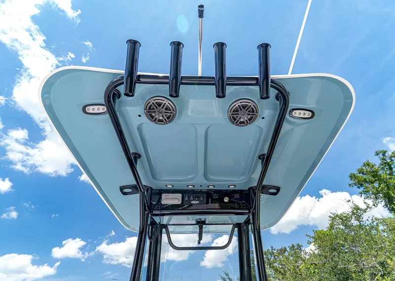 Slide: The Image of 2026 Sea Hunt Ultra 245 SE boat top view with speakers and rod holders against blue sky. - 18