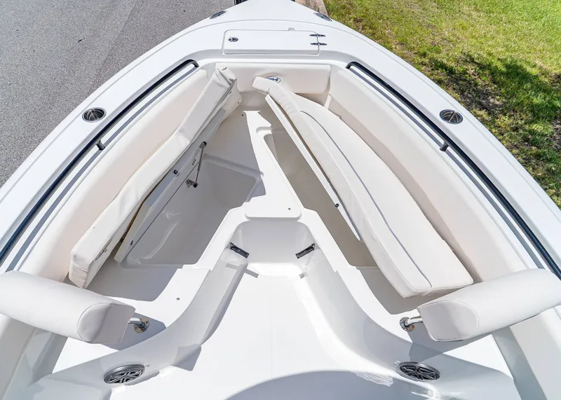 Slide: The Image of 2026 Sea Hunt Ultra 245 SE boat interior with white cushioned seating and sleek design. - 23