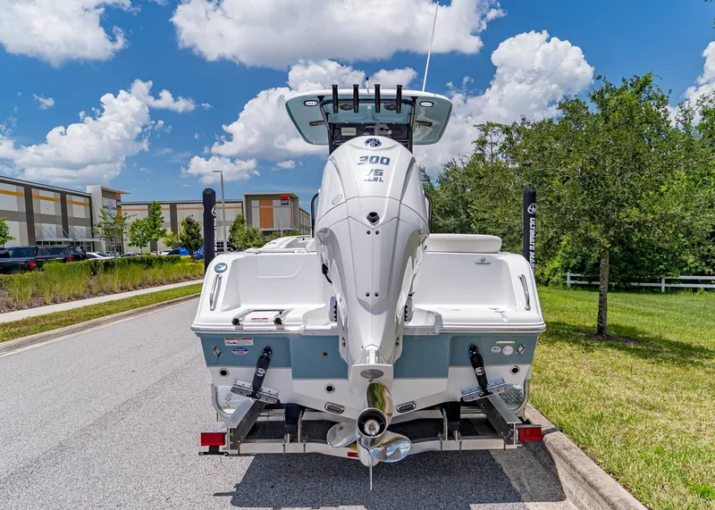 Slide: The Image of 2026 Sea Hunt Ultra 245 SE boat on trailer, parked outdoors under a blue sky. - 5