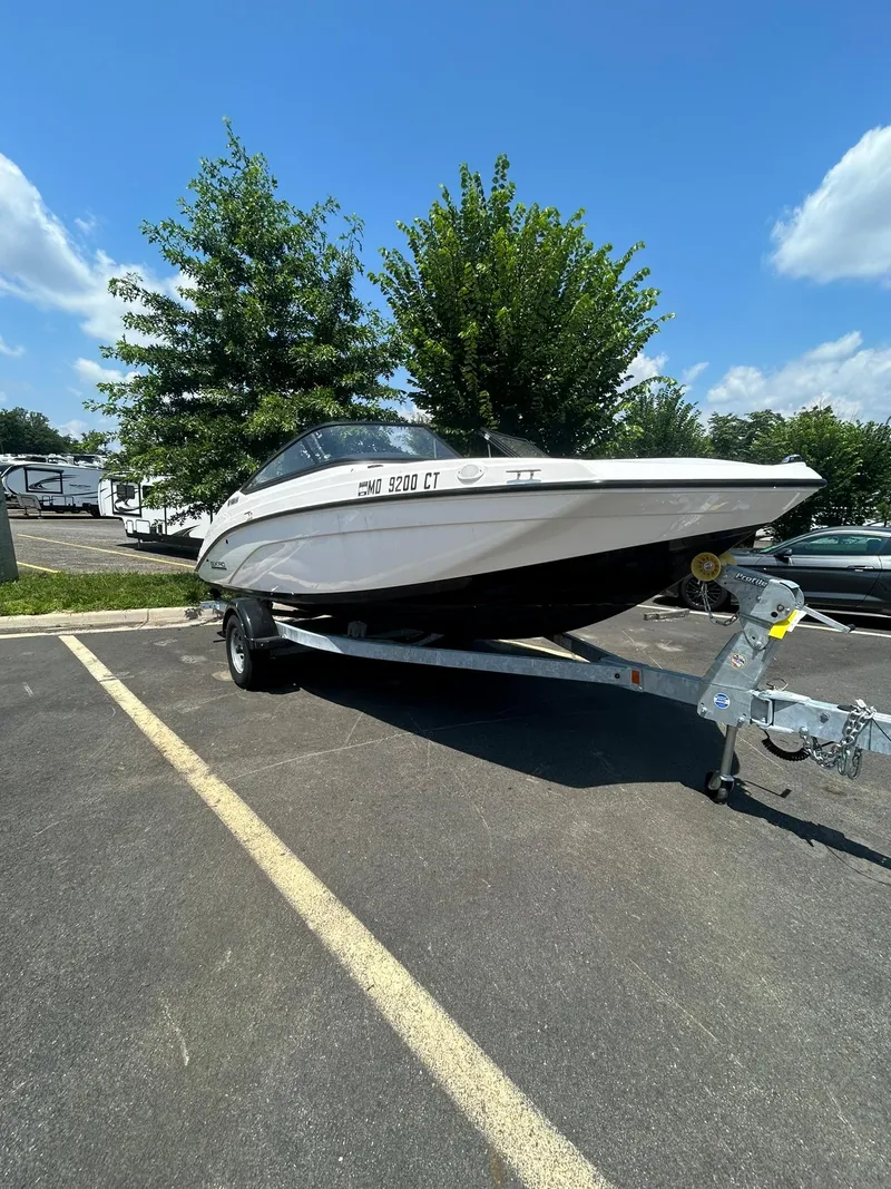 The Image of 2024 Yamaha Boats SX190 on trailer in sunny parking lot. - 0