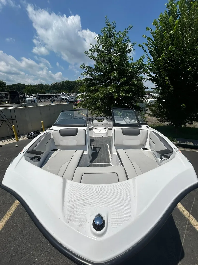 Slide: The Image of 2024 Yamaha Boats SX190, white interior, parked outdoors under a blue sky. - 6