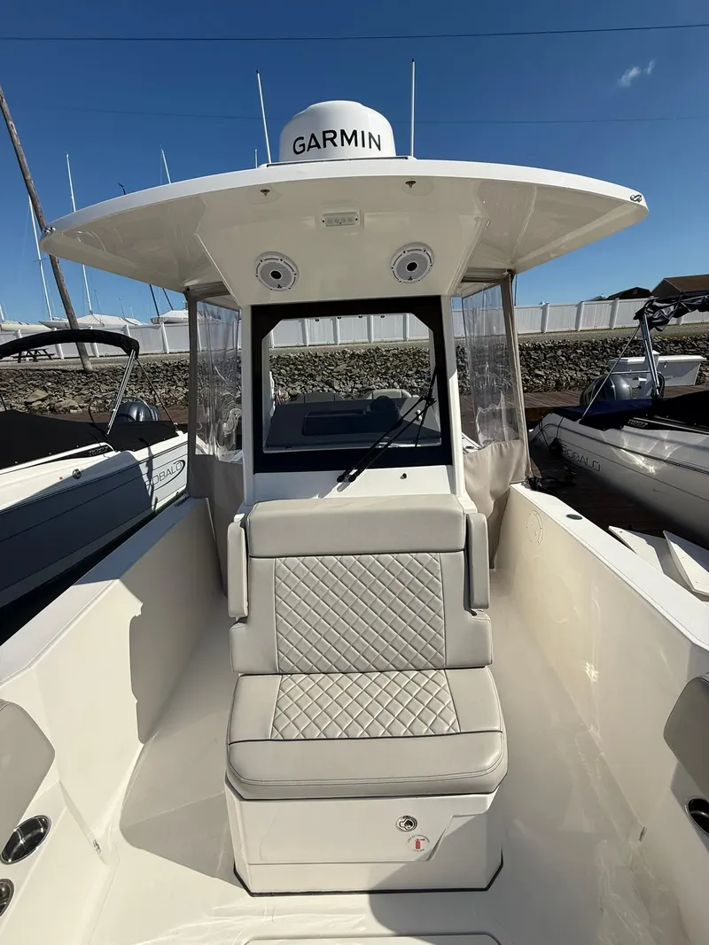 Slide: The Image of 2023 Pursuit S 268 Sport boat with Garmin equipment, featuring cushioned seating and sleek design. - 10