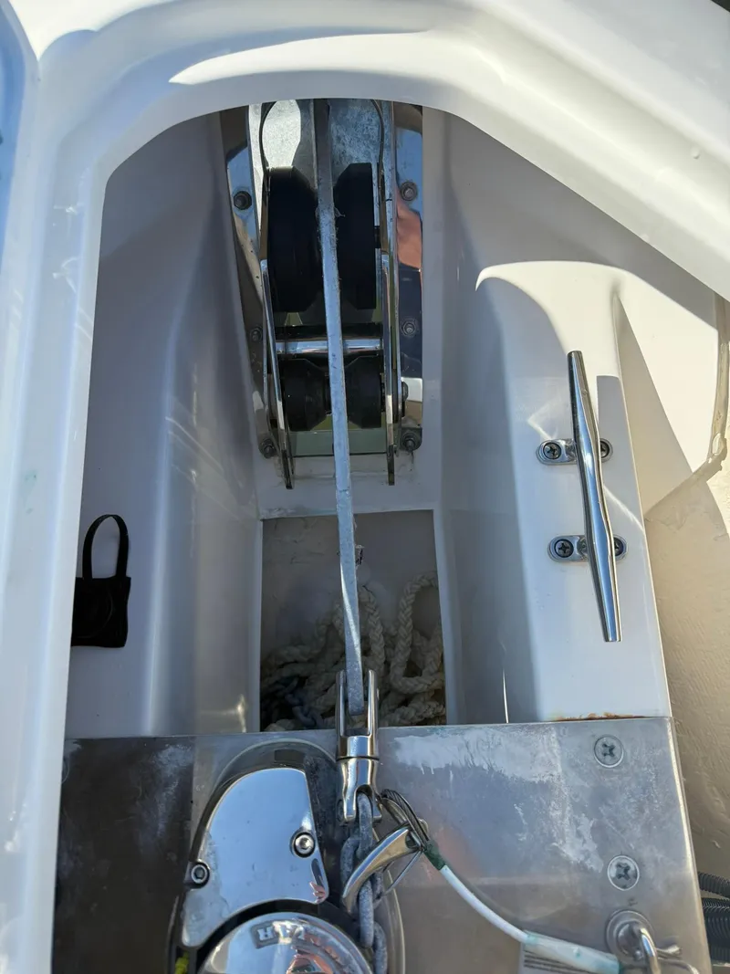 Slide: The Image of Anchor system of 2023 Pursuit S 268 Sport boat, featuring winch and rope storage. - 13