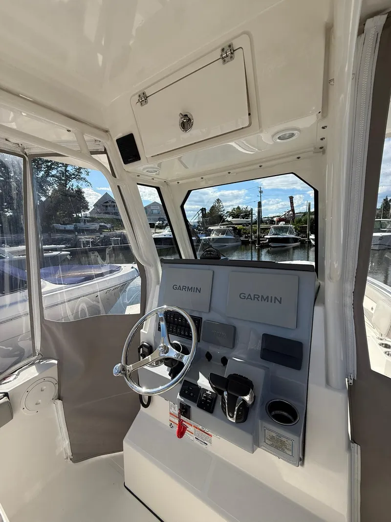 Slide: The Image of 2023 Pursuit S 268 Sport boat helm with Garmin navigation systems. - 14
