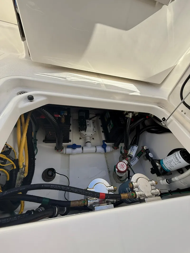 Slide: The Image of 2023 Pursuit S 268 Sport engine compartment with various cables and components. - 20