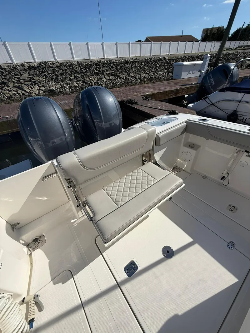 Slide: The Image of 2023 Pursuit S 268 Sport boat with dual engines and cushioned seating. - 21