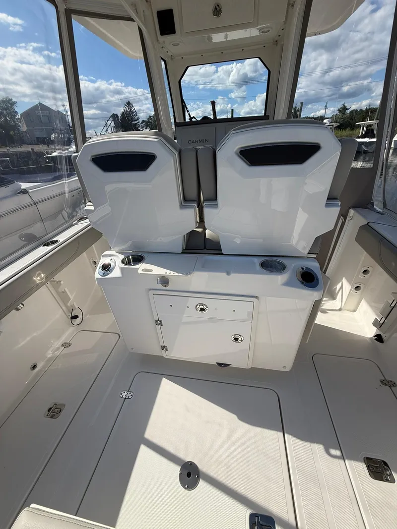 Slide: The Image of 2023 Pursuit S 268 Sport boat interior with seating and storage compartments. - 22