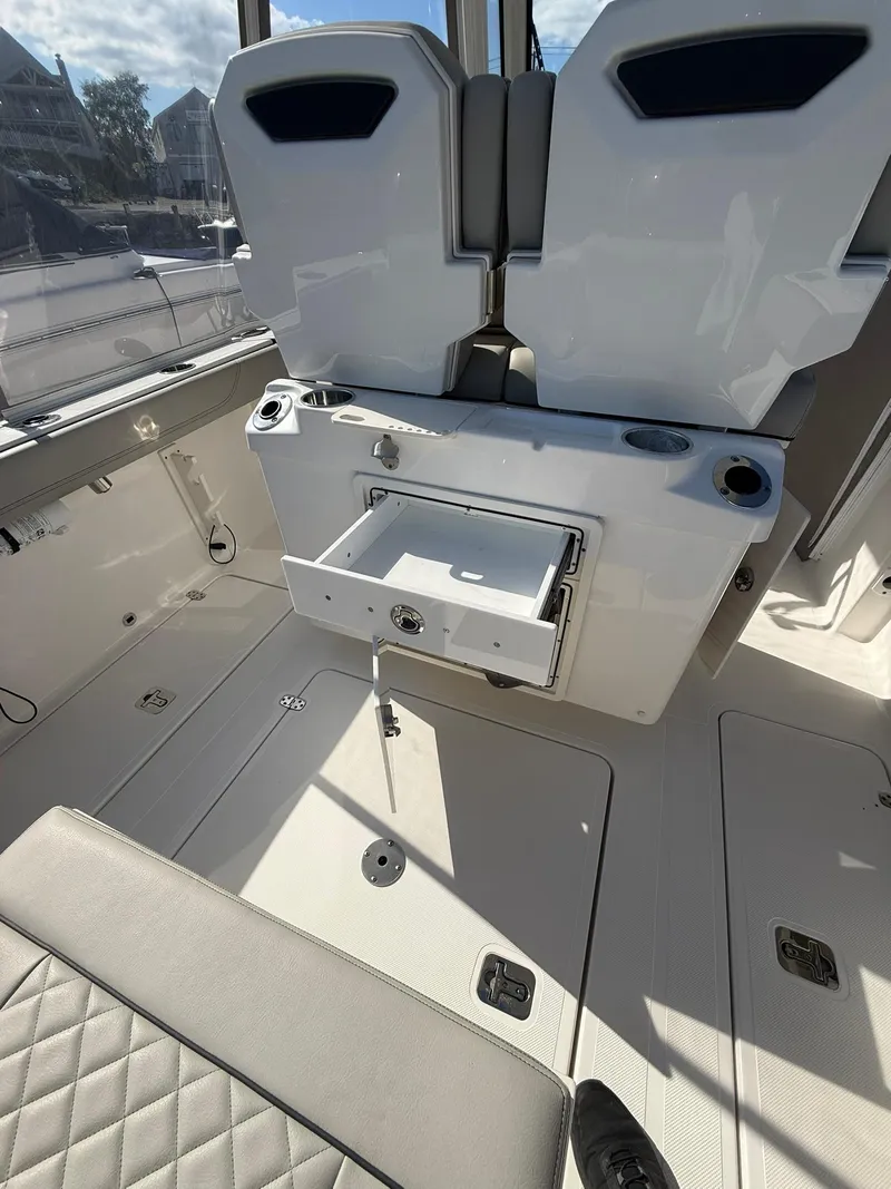 Slide: The Image of 2023 Pursuit S 268 Sport boat interior with seating and storage compartments. - 23