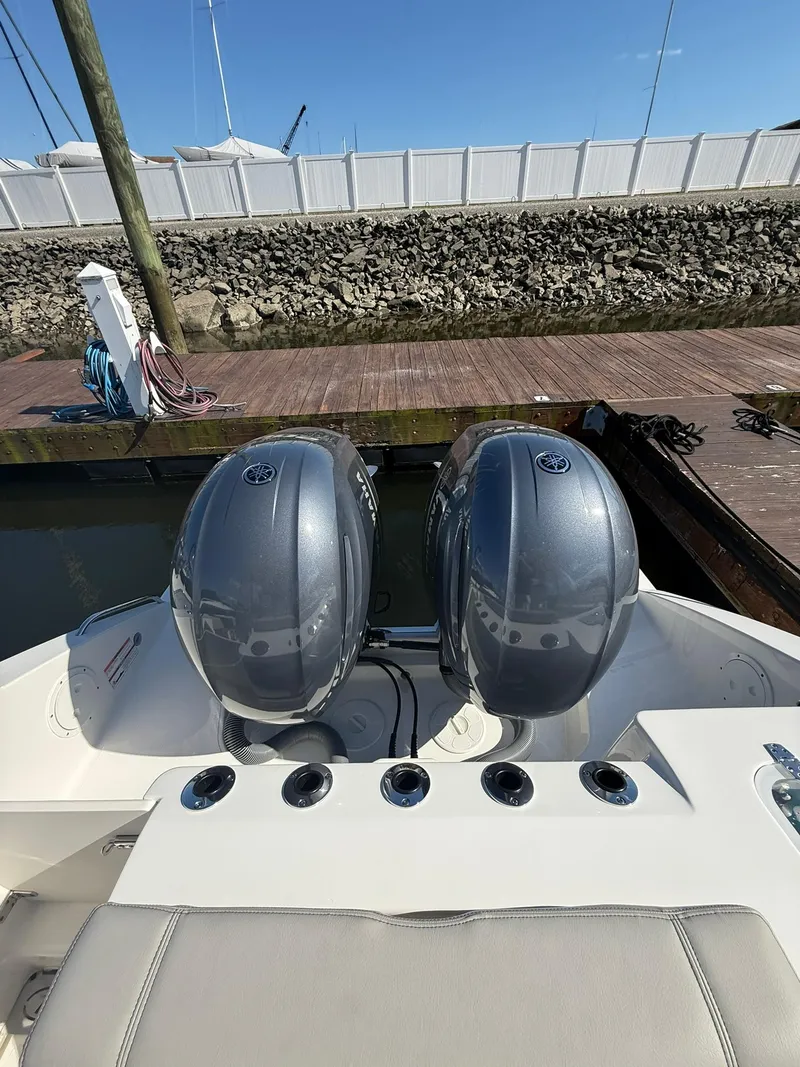Slide: The Image of 2023 Pursuit S 268 Sport boat with dual outboard engines at dock. - 25