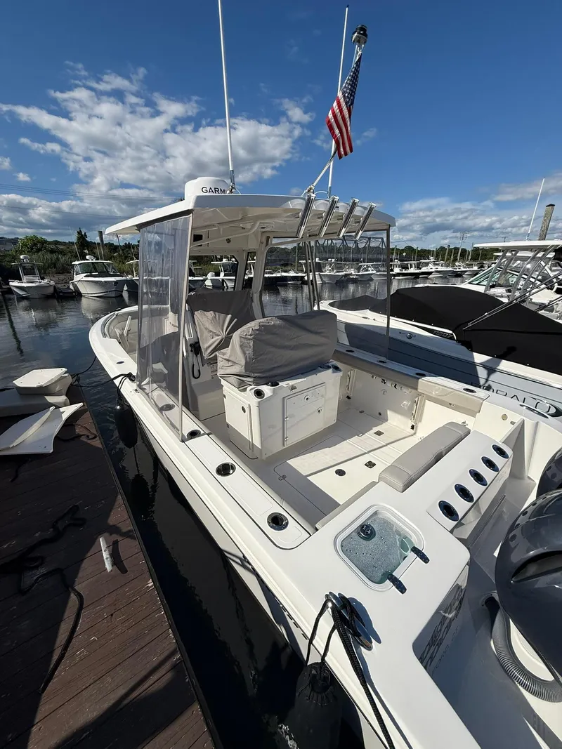 Slide: The Image of 2023 Pursuit S 268 Sport boat docked under clear sky. - 27