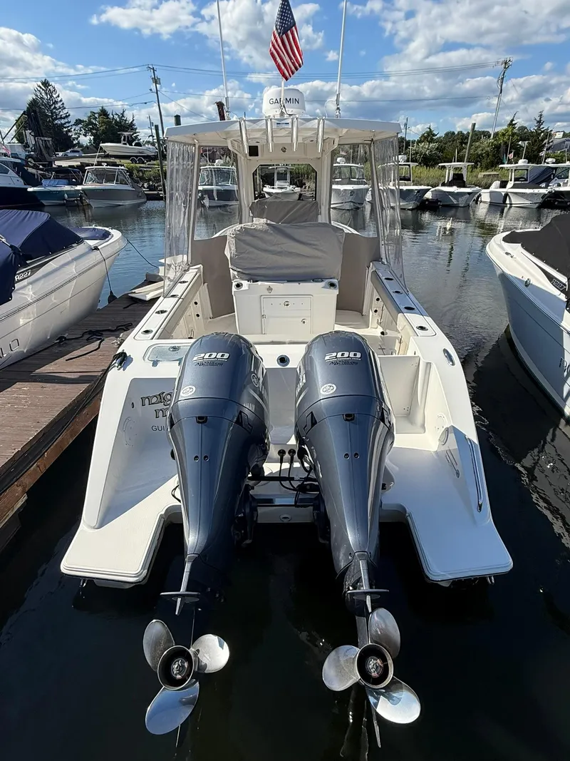 Slide: The Image of 2023 Pursuit S 268 Sport boat with dual engines docked at marina. - 3