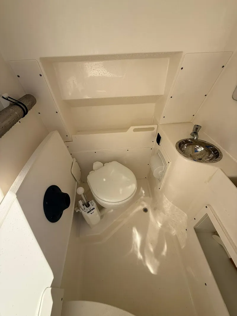 Slide: The Image of 2023 Pursuit S 268 Sport boat interior with toilet and sink. - 9
