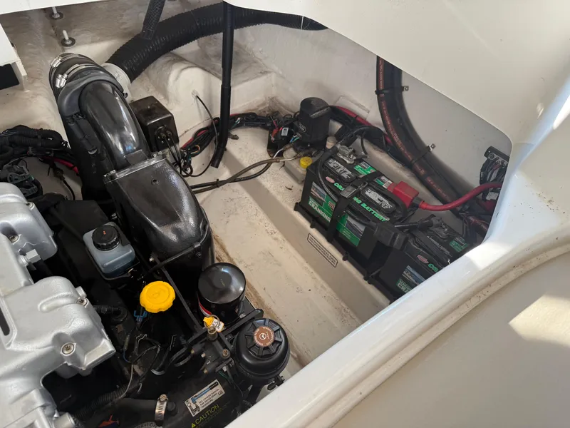 Slide: The Image of Engine compartment of a 2012 Sea Ray 270 SLX boat, showing batteries and components. - 12