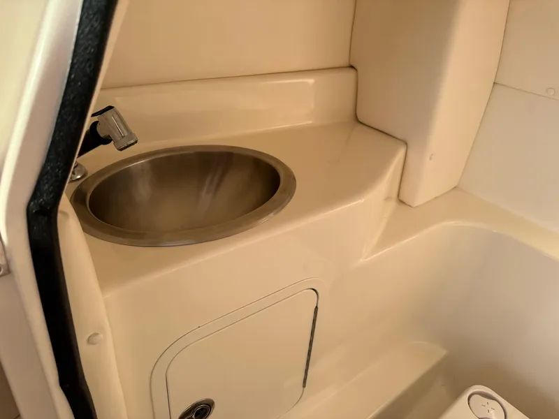 Slide: The Image of Interior sink area of 2012 Sea Ray 270 SLX boat, featuring a compact design. - 16
