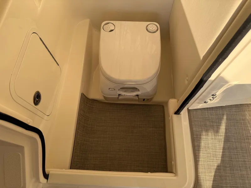 Slide: The Image of Interior of 2012 Sea Ray 270 SLX boat with portable toilet and storage compartment. - 17