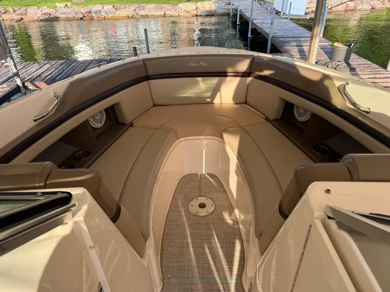 Slide: The Image of Interior of a 2012 Sea Ray 270 SLX boat with tan seating and dock view. - 20