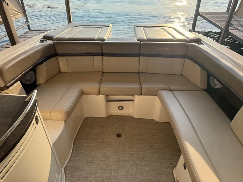 Slide: The Image of 2012 Sea Ray 270 SLX boat interior with beige seating and lake view. - 23