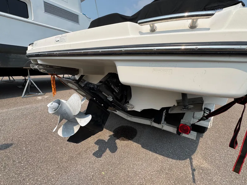 Slide: The Image of 2012 Sea Ray 270 SLX boat stern with propeller, parked on asphalt. - 27