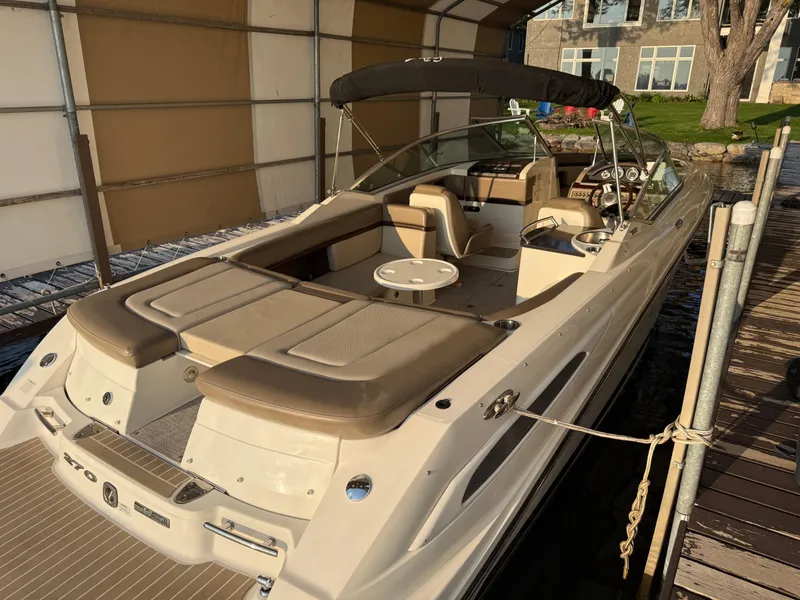 Slide: The Image of 2012 Sea Ray 270 SLX boat docked, featuring spacious seating and sleek design. - 3