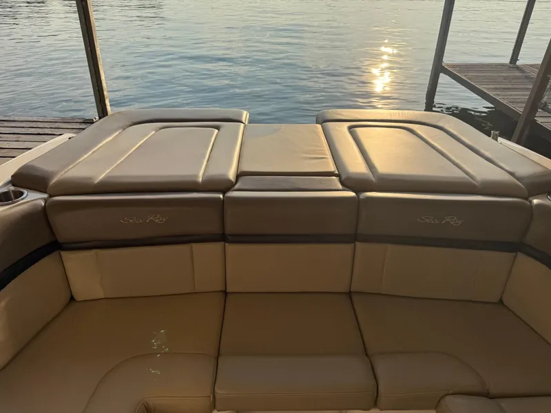 Slide: The Image of 2012 Sea Ray 270 SLX boat interior with tan leather seating by the water. - 8