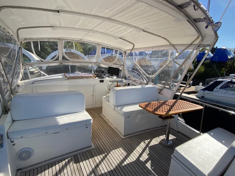 Slide: The Image of Spacious cockpit of 1992 Grand Banks 46 Europa yacht with seating and table. - 13