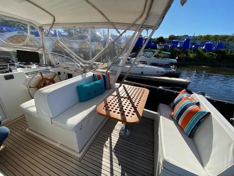 Slide: The Image of 1992 Grand Banks 46 Europa yacht interior with seating, table, and colorful cushions. - 14