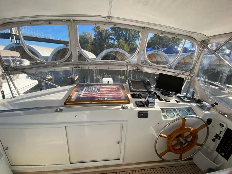 Slide: The Image of Helm of 1992 Grand Banks 46 Europa yacht with steering wheel and navigation equipment. - 15