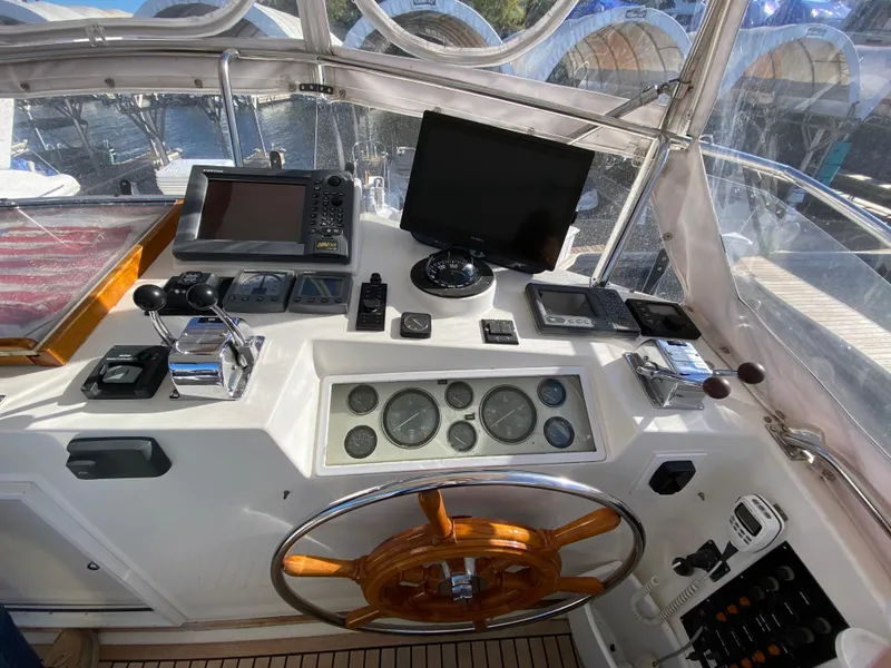 Slide: The Image of Helm of 1992 Grand Banks 46 Europa yacht with navigation instruments and wooden steering wheel. - 16