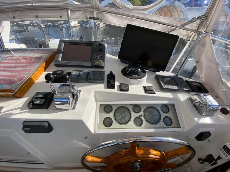 Slide: The Image of Helm of 1992 Grand Banks 46 Europa with navigation equipment and wooden steering wheel. - 18