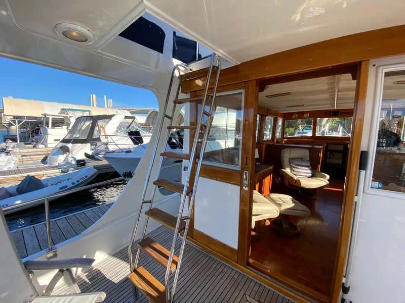 Slide: The Image of 1992 Grand Banks 46 Europa yacht interior with wooden accents and marina view. - 19