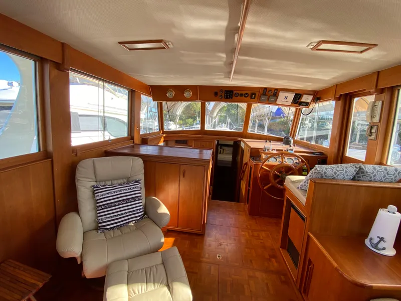 Slide: The Image of Interior of 1992 Grand Banks 46 Europa yacht, featuring wooden finishes and comfortable seating. - 24