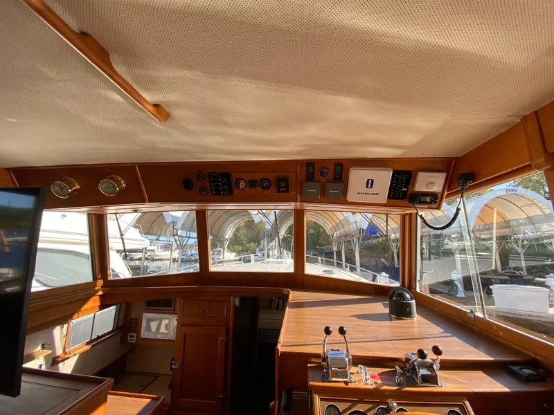 Slide: The Image of Interior view of 1992 Grand Banks 46 Europa yacht helm with wooden dashboard and controls. - 30