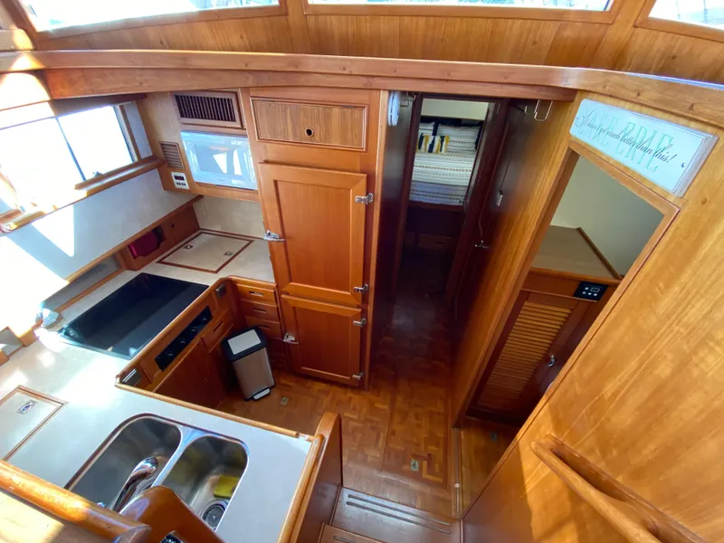 Slide: The Image of Interior of 1992 Grand Banks 46 Europa yacht, featuring wooden cabinetry and modern kitchen amenities. - 31
