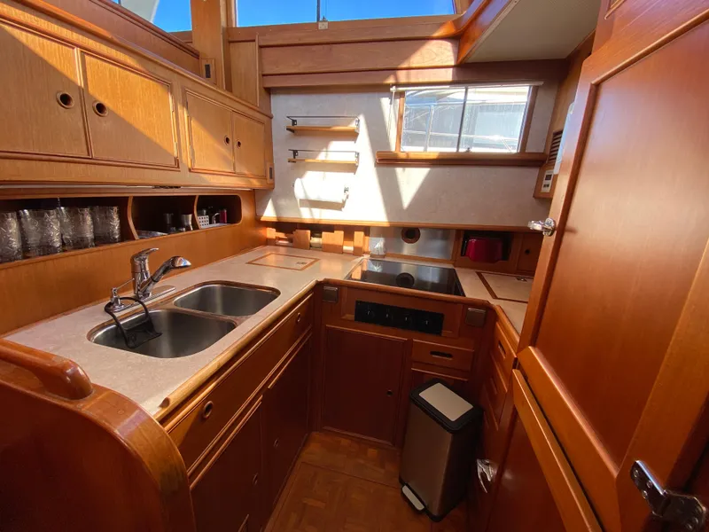 Slide: The Image of 1992 Grand Banks 46 Europa yacht kitchen with wooden cabinetry and modern appliances. - 32