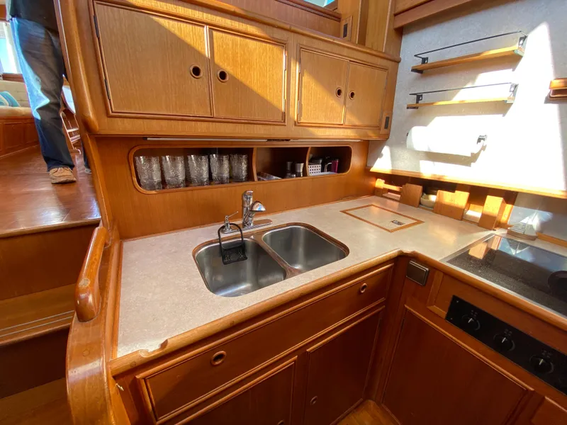 Slide: The Image of Galley kitchen in 1992 Grand Banks 46 Europa yacht with wooden cabinetry and dual sink. - 34