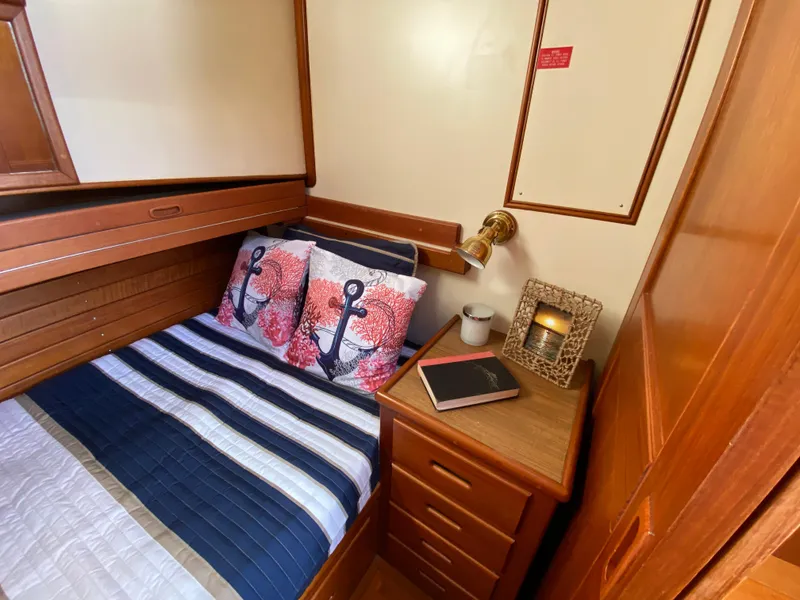 Slide: The Image of Cozy cabin interior of 1992 Grand Banks 46 Europa with nautical-themed bedding and wooden furnishings. - 41