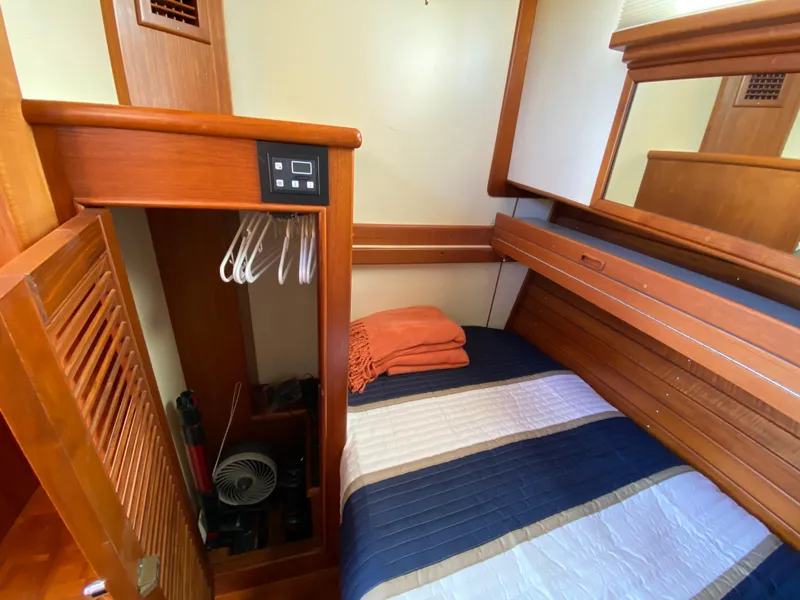 Slide: The Image of Cozy cabin interior of 1992 Grand Banks 46 Europa with bed, closet, and wooden accents. - 43